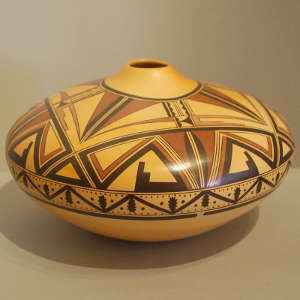 Black and red Zuni-inspired geometric design on a yellow ware jar with organic opening