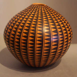 Geometric design on a black and yellow pot