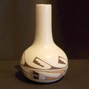 Band of red and black geometric designs on a tall neck whiteware vase