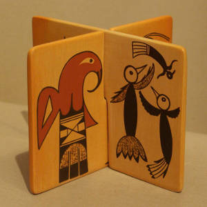 Red and black bird element designs on interlocking yellow ware tiles
