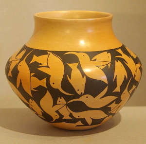 Hummingbirds and fish on a black on yellow jar