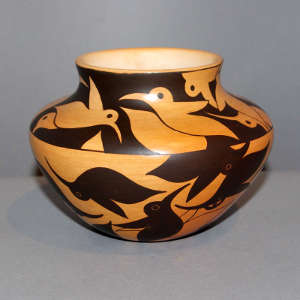 Night and day hummingbird design on a black on yellow jar