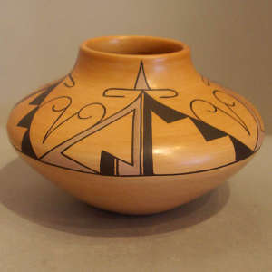 Four direction geometric design on a tan jar