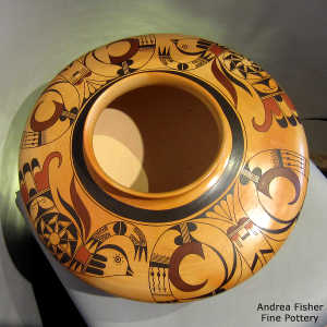 A bird element and geometric design on a polychrome yellow ware jar with fire clouds