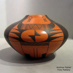 Four-direction bird element and geometric design on a black on red jar