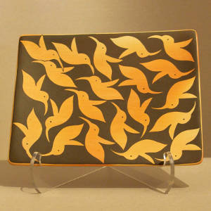 Hummingbird designs on a black on yellow ware tile