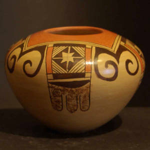 Four direction black and red bird element and shard designs on a yellowware jar
