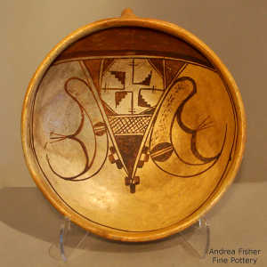 Click to see a larger version A Sikyátki-Revival stylized insect with a sky band and additional geometric design on a polychrome yellow ware bowl