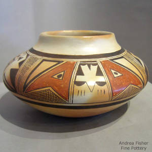 Red and black shard designs decorate a yellowware jar