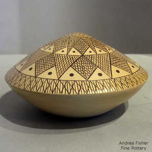 Black geometric design on a yellow war seed pot