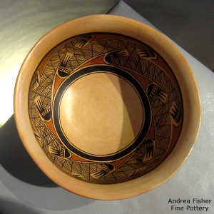Geometric design outisde and migration pattern design inside on a polychrome bowl