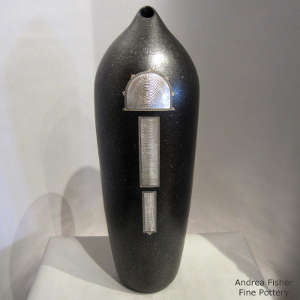 Sterling silver in shifting sands design inlaid on a black micaceous cylinder