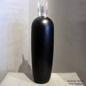 Silver tablita lid on a tall black micaceous cylinder