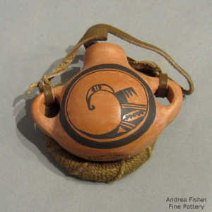 Bird elements and geometric design in black on a red canteen