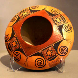 Bird element and geometric design on a polychrome flying saucer jar