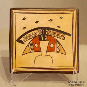 Stylized katsina design on a polychrome yellow ware tile