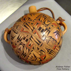 Bird element, shard and geometric design on a polychrome canteen