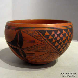 Bird element, small shard and geometric design in black on a red bowl