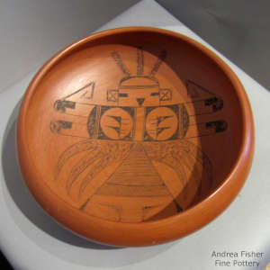 Black katsina design inside a red bowl polished inside and out