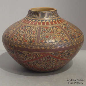 Red and black fine shard design on a yellow ware jar