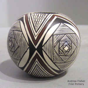 Awatovi star, fine line and geometric design on a miniature black and white seed pot