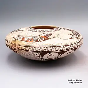 A polychrome Sikyátki-style jar with a band of scrolls around the shoulder, a speckled four lizards with geometric designs above the shoulder and a bird element and geometric design below