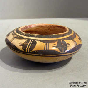 Bird element and geometric design on a black on yellow ware bowl