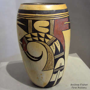 Black and red bird element and geometric design on a yellowware jar