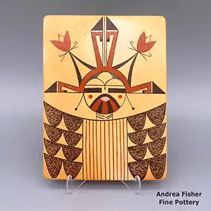 A katsina design and fire clouds decorate this polychrome tile