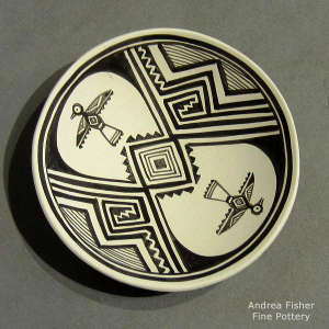 A thunderbird and geometric design on a black and white seed pot