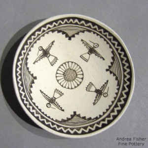 Black and white plate with thunderbird and geometric design