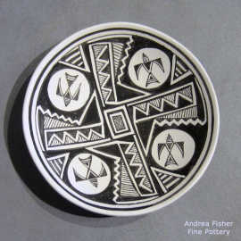 Black-on-white plate with a thunderbird, cloud, rain and geometric design