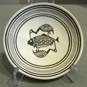 Bird and fish design on a black and white plate