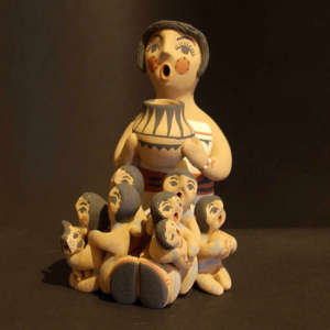 Eight children, a pot and a dog on a grandmother storyteller
