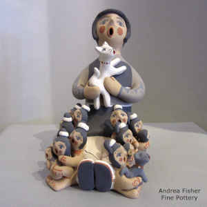13 children and a cat on a grandmother storyteller figure