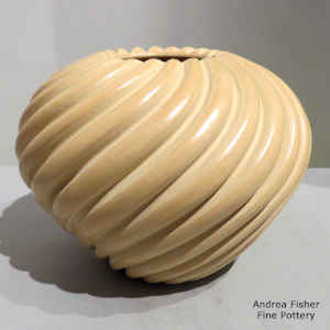 Spiral melon design carved into a buff-colored jar