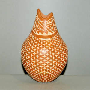 Sgraffito geometric design on a red jar