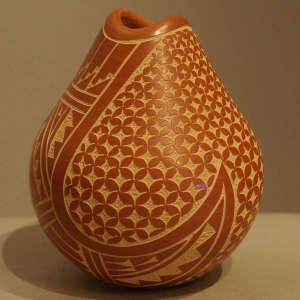Sgraffito geometric design on a polished red jar