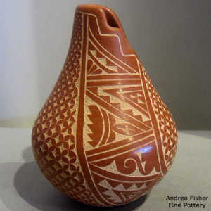 Sgraffito geometric design on a red jar with an organic opening