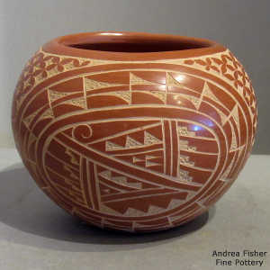 Sgraffito snowflake, medallion and geometric design on a red bowl