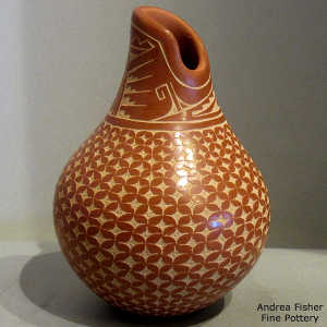 Sgraffito snowflake and geometric design on a red jar with an organic opening