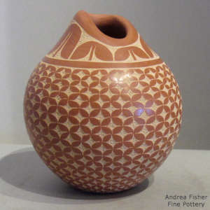 Sgraffito geometric design on a red jar with an organic opening