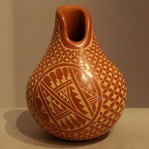 Sgraffito geometric design on a polished red jar