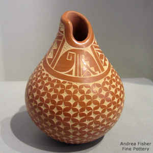 An organic opening on a polished red jar with a sgraffito kiva wstep and geometric design