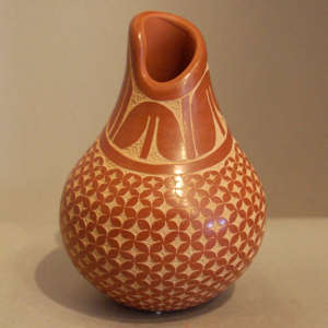 Sgraffito tulip and geometric design on a red jar