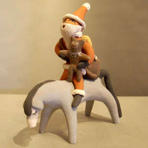 Santa Claus with a teddy bear on horseback figure