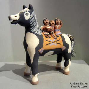 3 children riding on the back of a horse