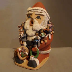 Ten children on a polychrome Santa Claus storyteller figure