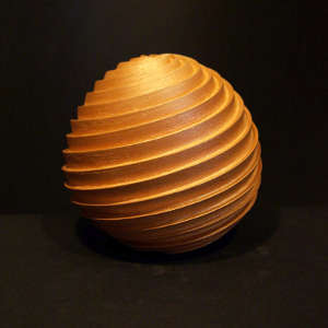 Spiral design deep carved into an orange micaceous jar