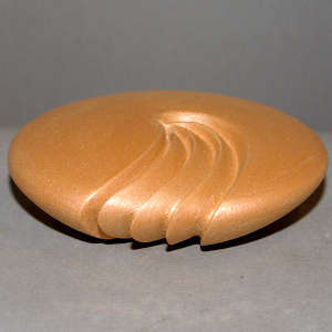 Three ribs carved in a golden micaceous seed pot